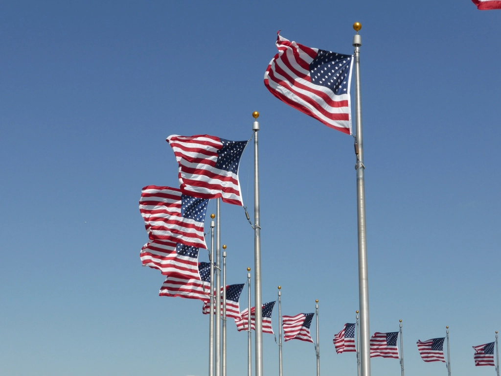 Close-up of the American flag waving against a blue sky